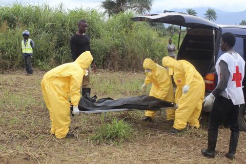 Health workers carry the body of an Ebola virus victim in the Waterloo district of Freetown, October 21, 2014. PHOTO BY REUTERS/Josephus Olu-Mamma