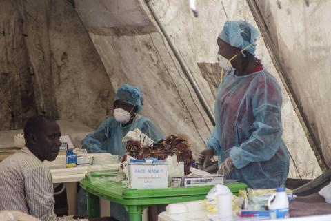 Health workers take blood samples for Ebola virus testing at a screening tent in the local government hospital in Kenema, Sierra Leone