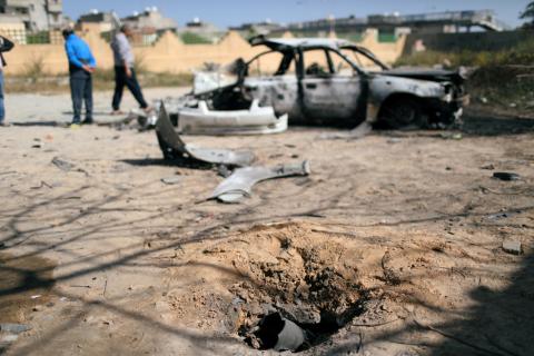 A hole made by an exploded missile is seen near a vehicle damaged by an overnight shelling in Abu Salim district in Tripoli, Libya, April 17, 2019. PHOTO BY REUTERS/Ahmed Jadallah