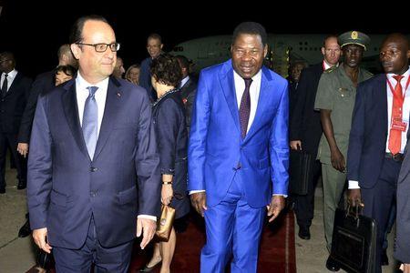 French President Francois Hollande (L) walks with Benin President Thomas Yayi Boni after landing in Cotonou, Benin, July 2, 2015. PHOTO BY REUTERS/Charles Placide Tossou