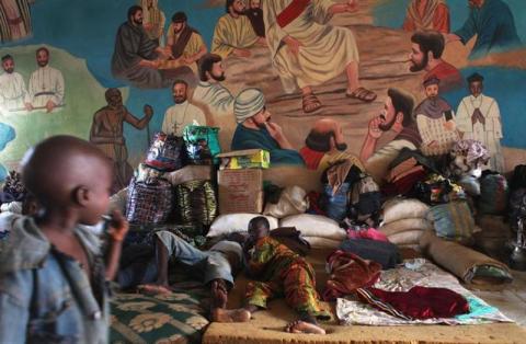 Displaced families rest next to their personal belongings as they take refugee from religious violence at the Catholic Church in Bossangao, north of capital Bangui in the Central African Republic