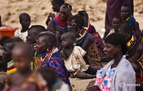 Turkana women and their children receive relief food supplies near the Kakuma Refugee Camp, Turkana District, northwest of Kenya's capital Nairobi. PHOTO BY REUTERS/Kabir Dhanji