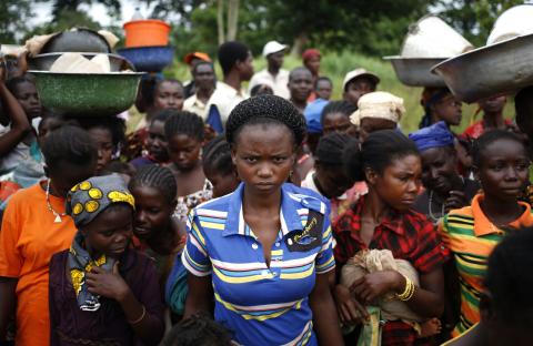 Internally displaced people wait for food distribution by a foreign non-governmental organisation (NGO) in the town of Boda