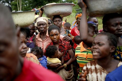 Internally displaced people wait for food distribution by a foreign non-governmental organization (NGO) in the town of Boda