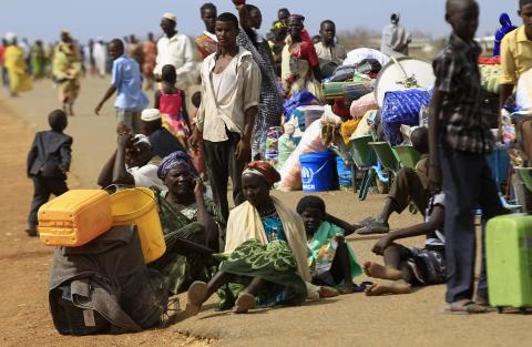 South Sudanese fleeing an attack on the South Sudanese town of Rank, wait with their belongings after arriving at a border gate in Joda, along the Sudanese border