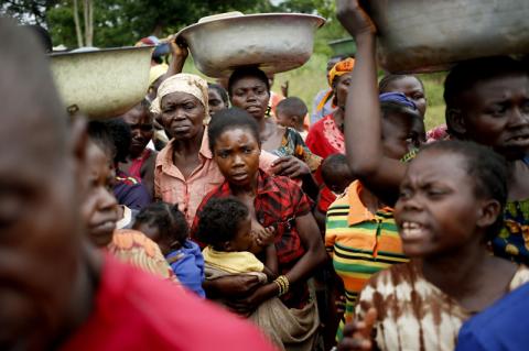 Internally displaced people wait for food distribution by a foreign non-governmental organization (NGO) in the town of Boda, April 15, 2014. PHOTO BY REUTERS/Goran Tomasevic