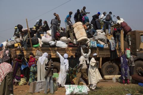 People load their belongings onto a truck as they prepare to leave during a repatriation by road to Chad at the capital Bangui