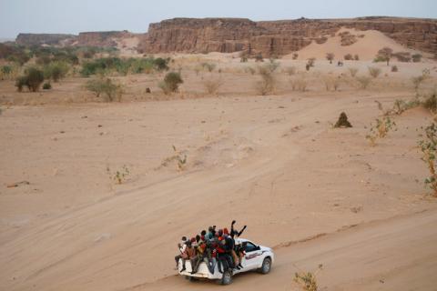 Migrants crossing the Sahara desert into Libya ride on the back of a pickup truck outside Agadez, Niger, May 9, 2016. PHOTO BY REUTERS/Joe Penney