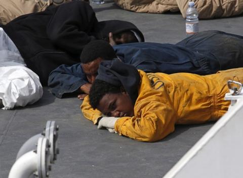 Surviving immigrants lie on the deck of the Italian coastguard ship Bruno Gregoretti in Senglea, in Valletta's Grand Harbour, April 20, 2015. PHOTO BY REUTERS/Darrin Zammit Lupi