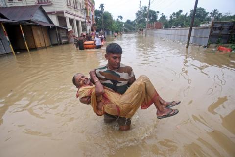 A member of Tripura State Rifles (TSR) carries a flood-affected woman to a safer place after heavy rains at Baldakhal village, on the outskirts of Agartala, India, July 14, 2019. PHOTO BY REUTERS/Jayanta Dey