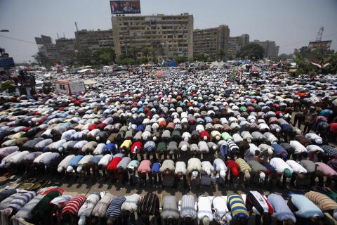 Supporters of then Egyptian President Mohamed Mursi perform prayers during a protest to show support to him at the Raba El-Adwyia mosque square in Cairo