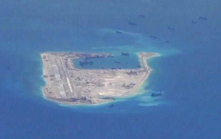 Chinese dredging vessels are purportedly seen in the waters around Fiery Cross Reef in the disputed Spratly Islands in the South China Sea in this still image from video taken by a P-8A Poseidon surveillance aircraft provided, May 21, 2015. PHOTO BY REUTERS/U.S. Navy