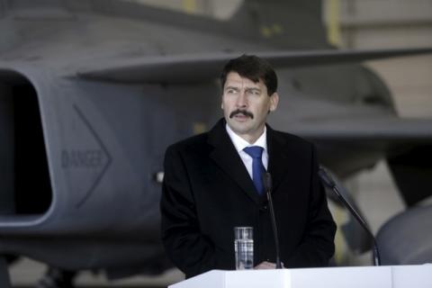 Hungarian President Janos Ader speaks to the media in front of a Hungarian Air Force Gripen JAS-39 fighter as he visits NATO's air policing mission over the Baltics in Siauliai Air Base, Lithuania, December 8, 2015. PHOTO BY REUTERS/Ints Kalnins