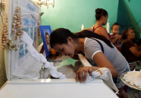 Jennelyn Olaires, 26, looks at the body of her partner Michael Siaron during his wake in Pasay, Metro Manila, Philippines, July 28, 2016. PHOTO BY REUTERS/Czar Dancel