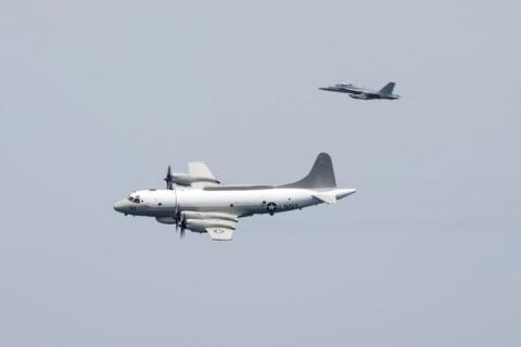 A U.S. Navy EP-3E Aries signals reconnaissance aircraft, escorted by an EA-18G Growler electronic warfare aircraft, performs a flyby over aircraft carrier USS Harry S. Truman in the Arabian Gulf, April 24, 2016. PHOTO BY REUTERS/U.S. Navy/Mass Communication Specialist 3rd Class Bobby J Siens