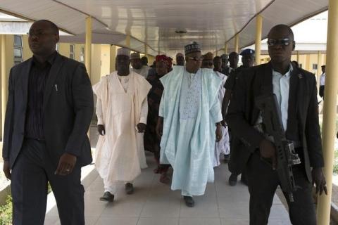 Governor of Borno state Kashim Shettima (C) leaves a hospital that is currently under construction in Maiduguri, May 22, 2014. PHOTO BY REUTERS/Joe Penney