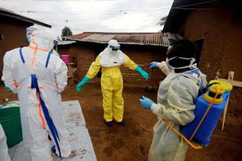 Kavota Mugisha Robert, a healthcare worker, who volunteered in the Ebola response, decontaminates his colleague after he entered the house of 85-year-old woman, suspected of dying of Ebola, in the eastern Congolese town of Beni in the Democratic Republic of Congo, October 8, 2019. PHOTO BY REUTERS/Zohra Bensemra