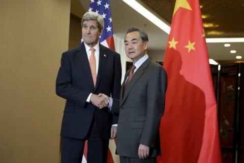 U.S. Secretary of State John Kerry (L) and Chinese Foreign Minister Wang Yi shake hands before their bilateral meeting at the Ministry of Foreign Affairs in Beijing, January 27, 2016. PHOTO BY REUTERS/Andy Wong