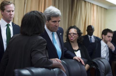 U.S. Secretary of State John Kerry (3rd L) speaks with aides prior to a meeting with South Sudan's President Salva Kiir at the President's Office in Juba