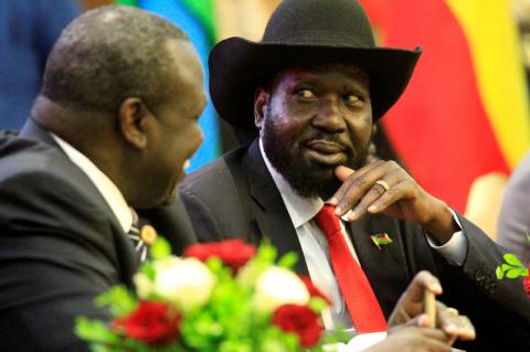 South Sudan's President Salva Kiir (R) talks to South Sudan's rebel leader Riek Machar as they sign a cease fire and power sharing agreement with in Khartoum, Sudan, August 5, 2018. PHOTO BY REUTERS/Mohamed Nureldin Abdallah