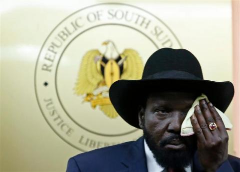 South Sudan's President Salva Kiir wipes his face during a news conference in Juba