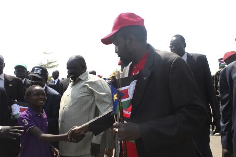 South Sudanese President Salva Kiir greets a child during a rally of the Sudan's People Liberation Movement (SPLM) youth in Juba