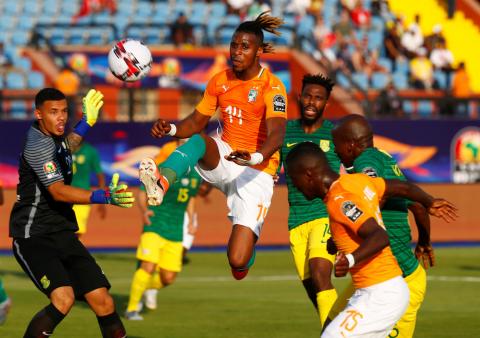 Ivory Coast's Jonathan Kodjia in action with South Africa's Rowen Williams. PHOTO BY REUTERS/Mohamed Abd El Ghany