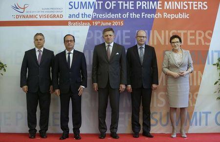 Francois Hollande poses for a family photo with Prime Ministers of the Visegrad Group (V4) Hungarian Prime Minister Viktor Orban (L) Slovakia's Prime Minister Robert Fico (C) Czech Republic's Prime Minister Bohuslav Sobotka (2nd R) and Poland's Prime Minister Ewa Kopacz (R) on arrival for the Visegrad Group summit in Bratislava, Slovakia, June 19, 2015. PHOTO BY REUTERS/David W Cerny