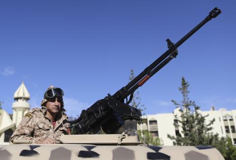 A member of the Libyan army guards the streets following yesterday's clashes in Benghazi