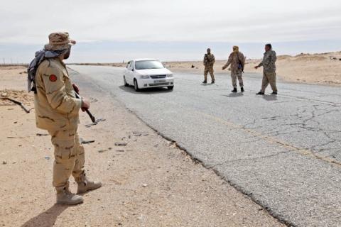 Libyan soldiers manning a military outpost, stop a car at a checkpoint in Wadi Bey, west of the city of Sirte, which is held by Islamic State militants, February 23, 2016. PHOTO BY REUTERS/Ismail Zitouny