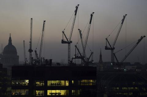 Offices are seen at dusk as St. Paul's cathedral and construction cranes are seen on the skyline in the City of London, Britain, November 2, 2015. PHOTO BY REUTERS/Toby Melville