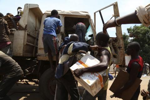 Christians carry property left behind by the Muslim community who were evacuated from the PK12 neighbourhood in Bangui