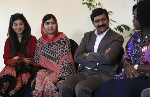 Pakistani schoolgirl activist Malala Yousafzai (2nd L) sits with her father Ziauddin Yousafzai (2nd R) and Malala Fund CEO Shiza Shahid (L) during a meeting with the leaders of the #BringBackOurGirls Abuja campaign group, in Abuja