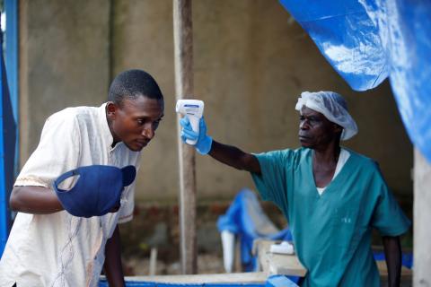 health worker measures the temperature of a man entering the ALIMA (The Alliance for International Medical Action) Ebola treatment centre in Beni, in the Democratic Republic of Congo, April 1, 2019. PHOTO BY REUTERS/Baz Ratner