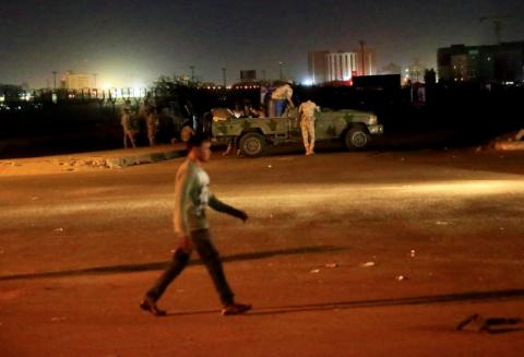 A civilian walks past members of the Sudanese Rapid Support Forces (RSF) are seen near the area where gunmen opened fire outside buildings used by Sudan's National Intelligence and Security Service (NISS) in Khartoum, Sudan January 14, 2020. PHOTO BY REUTERS/Mohamed Nureldin Abdallah