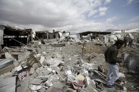 A man walks through the debris outside a tea factory after it was hit by Saudi-led air strikes in Yemen's capital Sanaa, January 30, 2016. PHOTO BY REUTERS/Mohamed al-Sayaghi