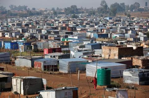 A man is seen walking at an informal settlement located next to Lenasia, south of Johannesburg, South Africa, May 30, 2018. PHOTO BY REUTERS/Siphiwe Sibeko