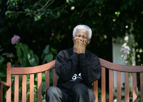 Nelson Mandela laughs with journalists and performers participating in the second 46664 AIDS awareness campaign concert near the small Southern Cape province town of George. PHOTO BY REUTERS/Mike Hutchings