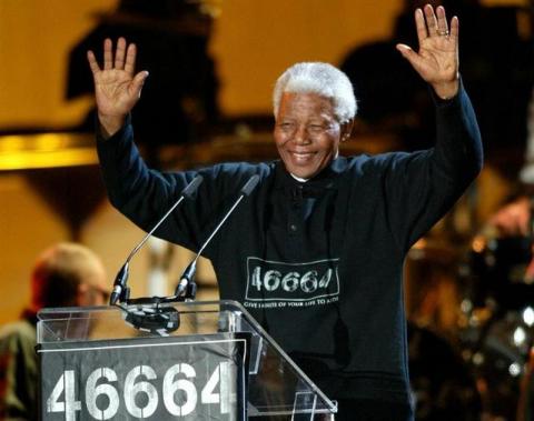 Nelson Mandela waves to crowds at the "46664" Aids benefit concert in Cape Town