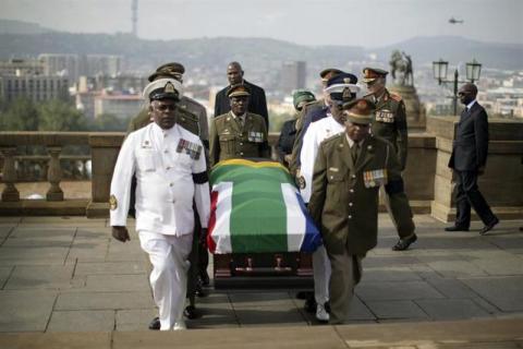 Military personnel carry the remains of the late Nelson Mandela at the Union Buildings in Pretoria