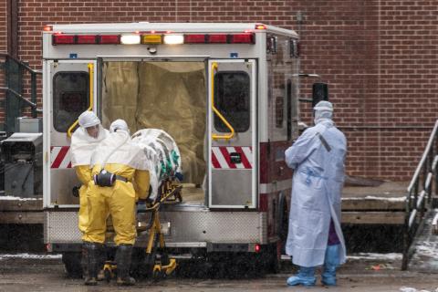 Dr. Martin Salia is placed on a stretcher upon his arrival at the Nebraska Medical Center Biocontainment Unit in Omaha, Nebraska, November 15, 2014. PHOTO BY REUTERS/Brian C. Frank