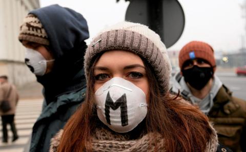 People wears masks as they take part in anti-smog demonstration demanding law regulations protecting citizens from smog in Warsaw, January 24, 2017. PHOTO BY REUTERS/Agency Gazeta/Kuba Atys