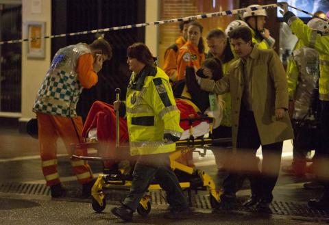 People receive medical attention after part of the ceiling at the Apollo Theatre on Shaftesbury Avenue collapsed in central London