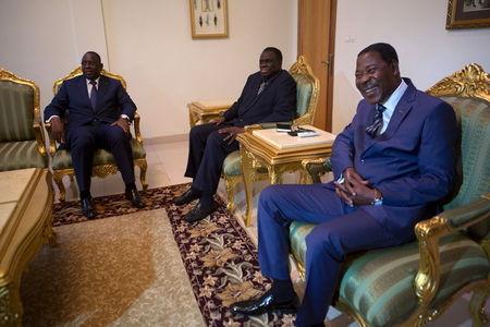 Senegalese President Macky Sall (L) and Beninois President Thomas Boni Yayi (R) pose for a picture with Burkinabe transitional President Michel Kafando (C) at the president's residence in Ouagadougou, Burkina Faso, September 19, 2015. PHOTO BY REUTERS/Joe Penney