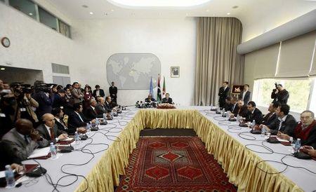 Special Representative of the Secretary-General for Libya and Head of United Nations Support Mission in Libya (UNSMIL), Bernardino Leon (back R), speaks as Algeria's Minister of African and Maghreb Affairs, Abdelkader Messahel (back L), listens as they head talks with Libyan political leaders and rivals in Algiers, March 10, 2015. PHOTO BY REUTERS/Ramzi Boudina