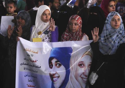 Members of the Muslim Brotherhood and supporters of ousted Egyptian President Mohamed Mursi rally against the military and interior ministry