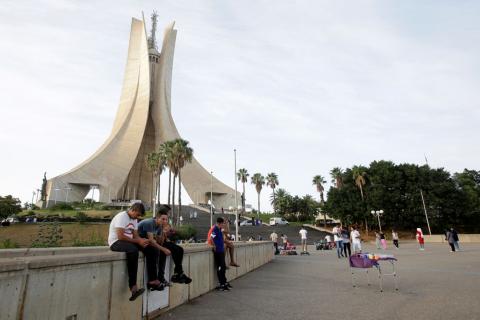 Youths sit near the Martyrs' Memorial in Algiers, Algeria, September 10, 2018. PHOTO BY REUTERS/Ramzi Boudina