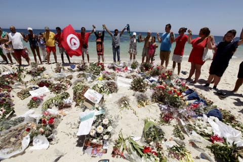 People join hands as they observe a minute's silence in memory of those killed in a by an Islamist gunman. PHOTO BY REUTERS/Anis Mili