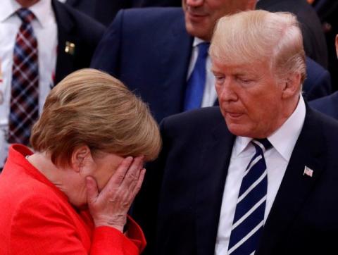 German Chancellor Angela Merkel reacts next to U.S. President Donald Trump during the G20 leaders summit in Hamburg, Germany July 7, 2017. PHOTO BY REUTERS/Philippe Wojazer