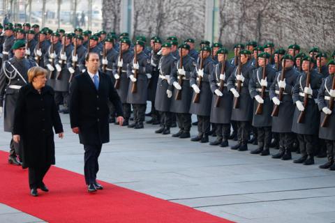 German Chancellor Angela Merkel and Tunisian Prime Minister Youssef Chahed review the guard of honour at the Chancellery in Berlin, Germany, February 14, 2017. PHOTO BY REUTERS/Hannibal Hanschke